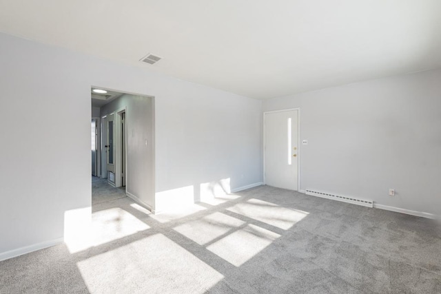 carpeted spare room featuring a baseboard radiator