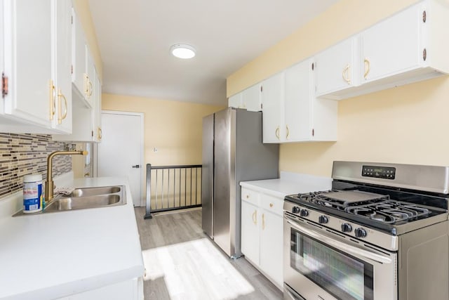 kitchen with white cabinetry, sink, decorative backsplash, stainless steel appliances, and light hardwood / wood-style flooring