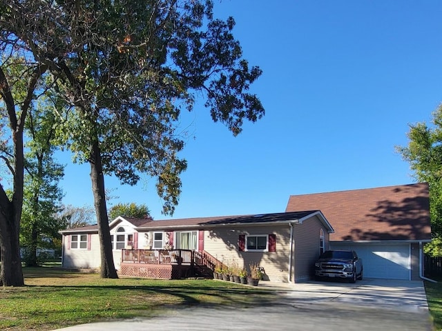 ranch-style house with a garage and a front lawn