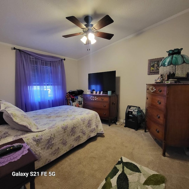 carpeted bedroom with ceiling fan, a textured ceiling, and ornamental molding