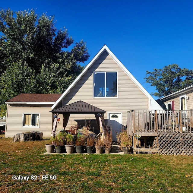 back of property featuring a gazebo, a yard, and a wooden deck