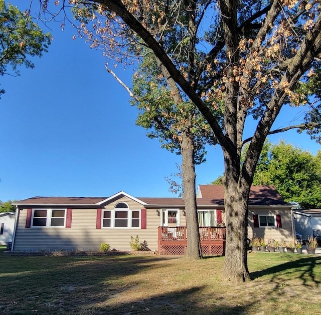 ranch-style house with a front yard and a deck