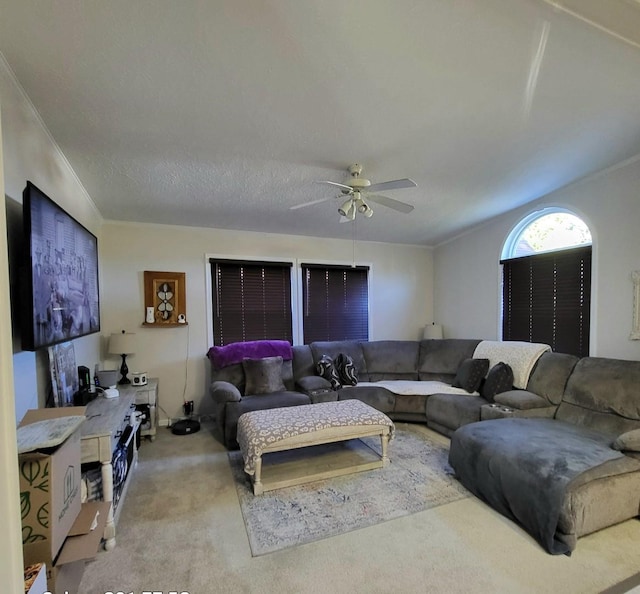 living room with a textured ceiling, light colored carpet, ceiling fan, and ornamental molding