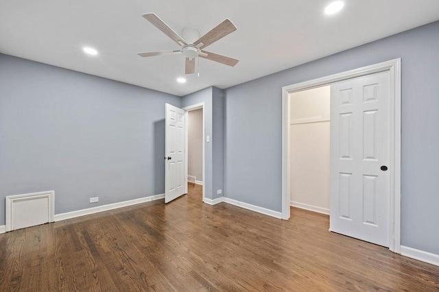 unfurnished bedroom featuring ceiling fan, a closet, and dark hardwood / wood-style floors