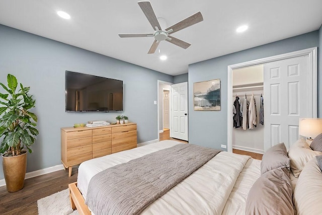 bedroom with dark hardwood / wood-style floors, ceiling fan, and a closet