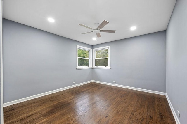 spare room featuring ceiling fan and dark wood-type flooring