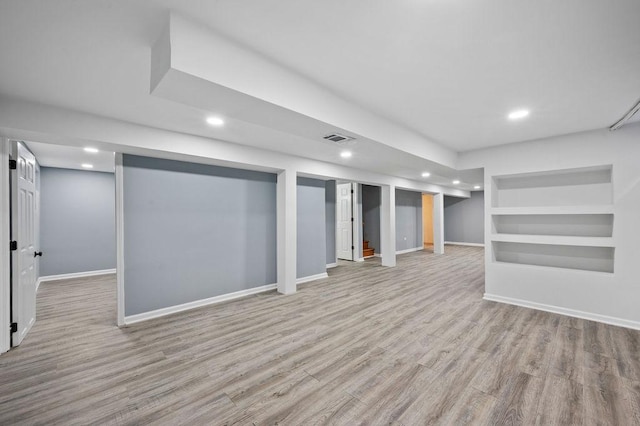 basement with light hardwood / wood-style floors