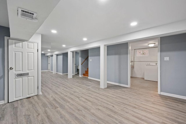 basement featuring washer / clothes dryer and light hardwood / wood-style floors