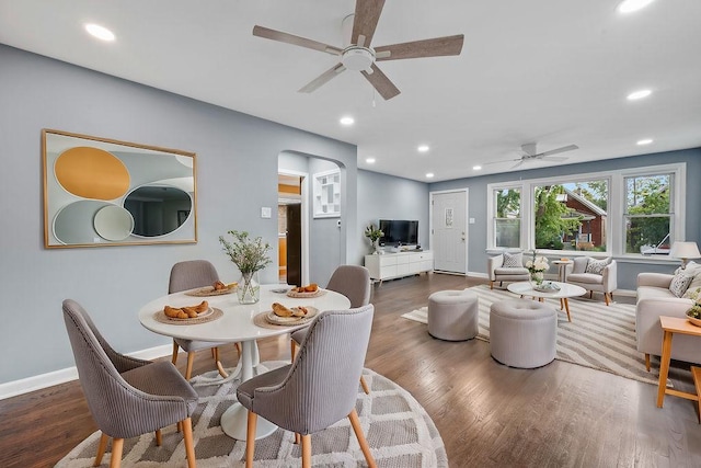 dining space featuring ceiling fan and dark hardwood / wood-style flooring