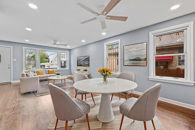 dining space with ceiling fan and hardwood / wood-style floors