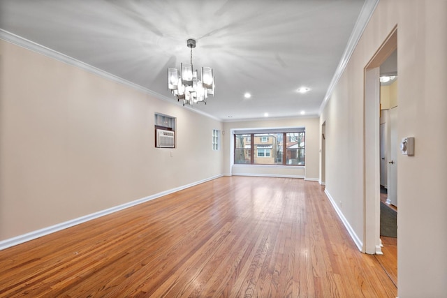 empty room featuring light wood finished floors, recessed lighting, an inviting chandelier, ornamental molding, and baseboards