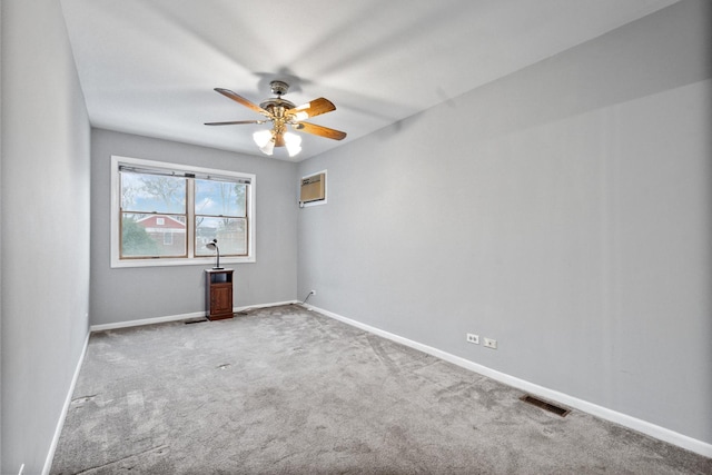 unfurnished room featuring carpet floors, baseboards, visible vents, and a ceiling fan