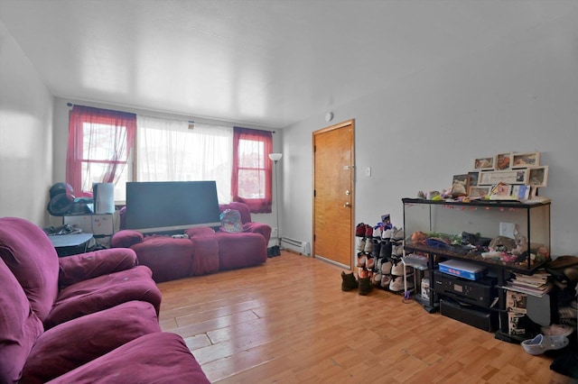 living room with a baseboard radiator and wood-type flooring