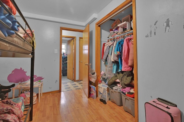 hallway with hardwood / wood-style floors