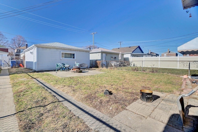 back of property featuring a patio, a yard, and a fire pit