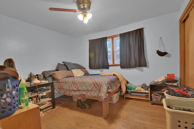 bedroom with ceiling fan and light hardwood / wood-style floors