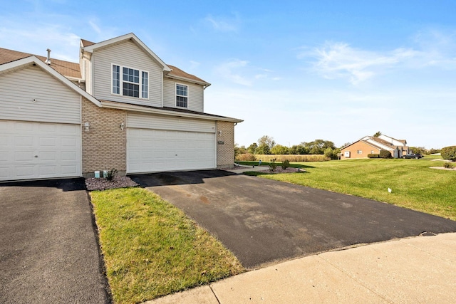 view of front facade with a front yard and a garage