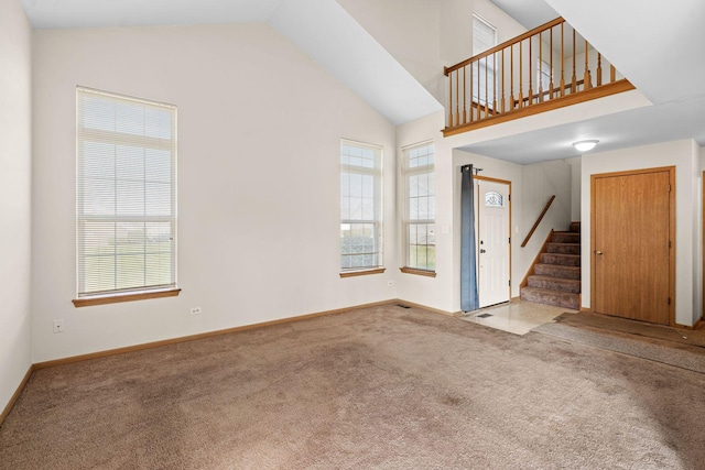 carpeted foyer entrance with lofted ceiling