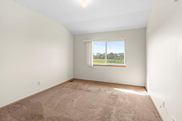 empty room with carpet and lofted ceiling