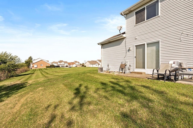 view of yard featuring central AC and a patio area