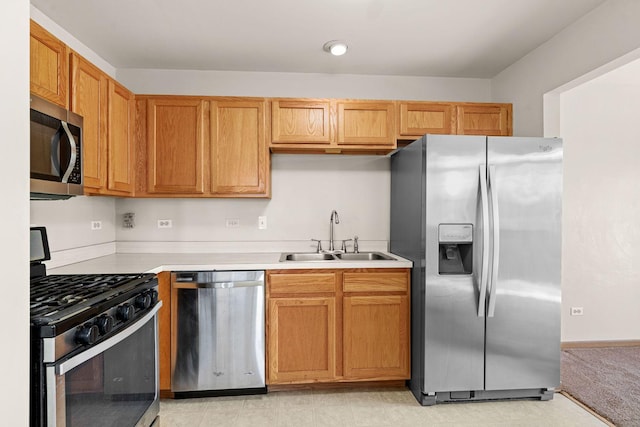 kitchen featuring light tile patterned flooring, stainless steel appliances, and sink