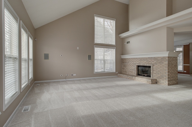 unfurnished living room with light carpet and high vaulted ceiling