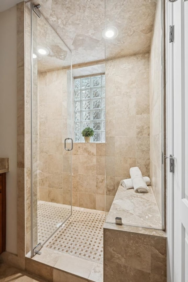 bathroom featuring a shower with door