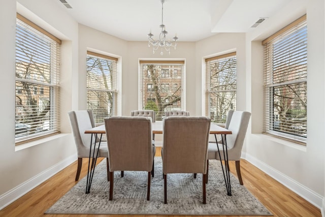 dining room featuring hardwood / wood-style floors and a notable chandelier