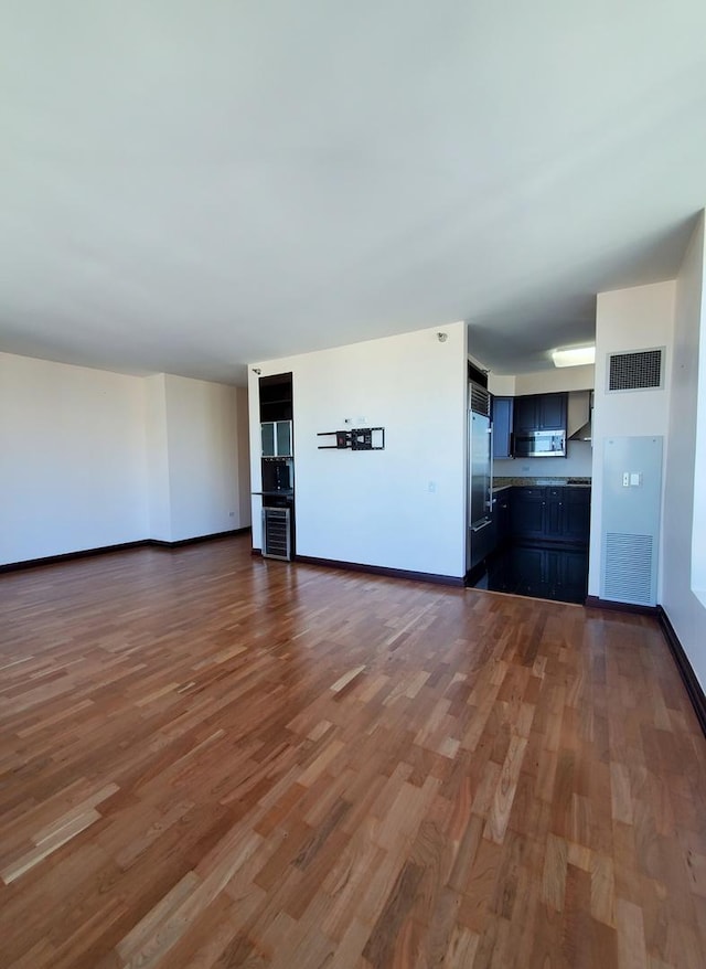 unfurnished living room featuring dark hardwood / wood-style flooring