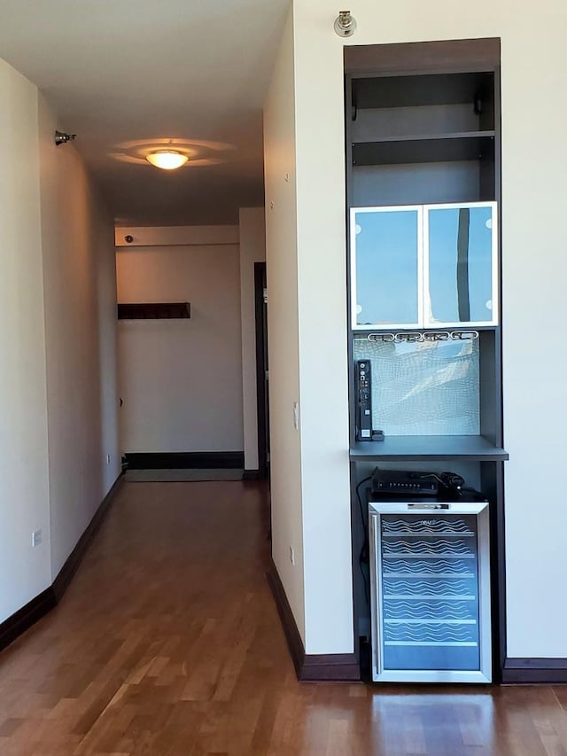 corridor with dark wood-type flooring and wine cooler