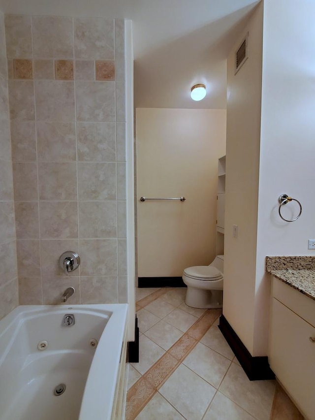 bathroom featuring tile patterned flooring, vanity, and toilet