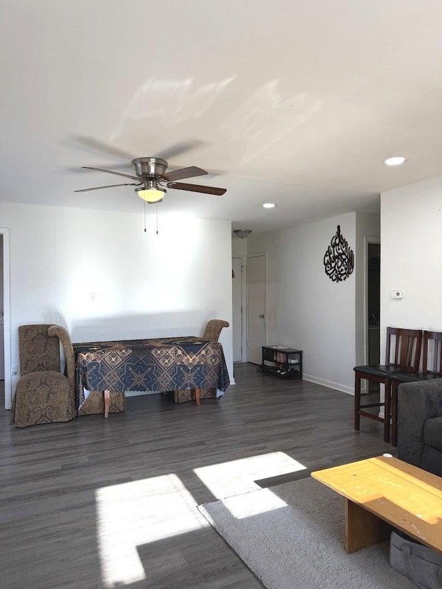 living area with recessed lighting, a ceiling fan, and wood finished floors