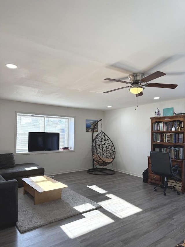 unfurnished living room featuring ceiling fan, baseboards, wood finished floors, and recessed lighting