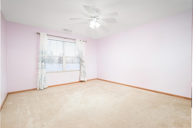 empty room with ceiling fan and light carpet