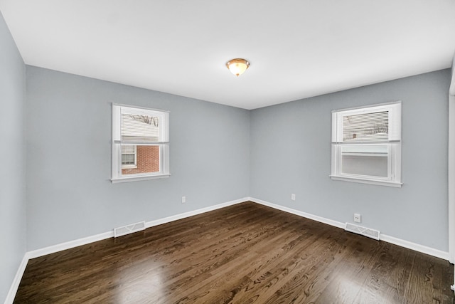 spare room featuring dark hardwood / wood-style floors