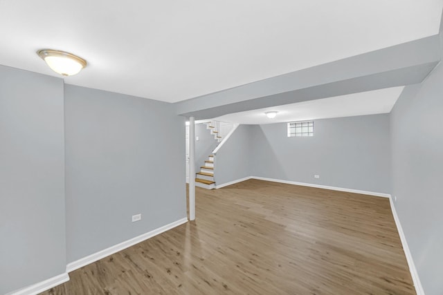 basement with hardwood / wood-style floors