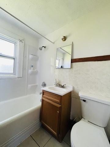 full bathroom featuring tile patterned flooring, bathtub / shower combination, vanity, and toilet