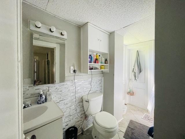 bathroom with tile patterned flooring, vanity, and toilet