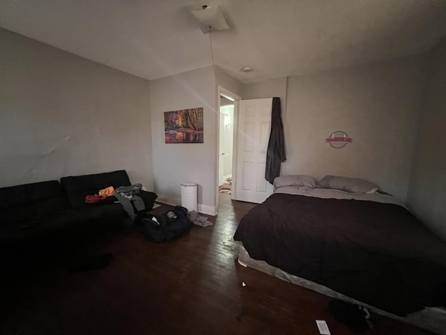 bedroom with dark wood-type flooring