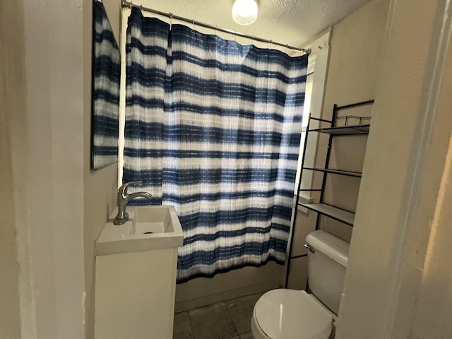 bathroom featuring tile patterned floors, a textured ceiling, shower / tub combo, and toilet