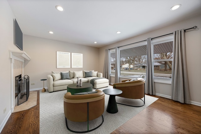 living room with hardwood / wood-style floors and a fireplace