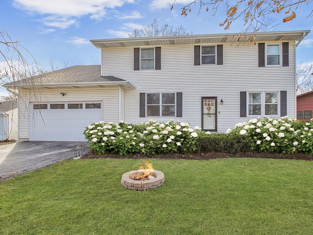 view of front of home featuring a front yard and a garage