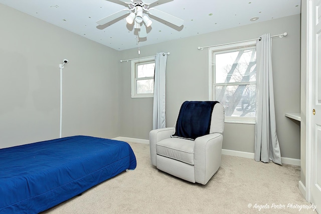 bedroom with ceiling fan and light colored carpet