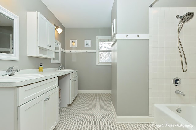 bathroom with vanity, tile patterned flooring, and tiled shower / bath combo