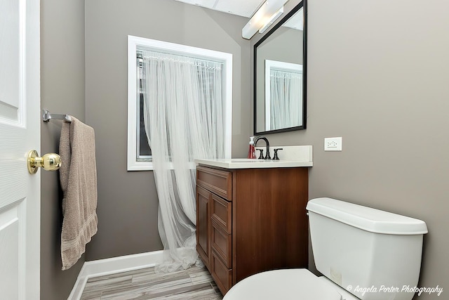 bathroom featuring hardwood / wood-style floors, toilet, and vanity