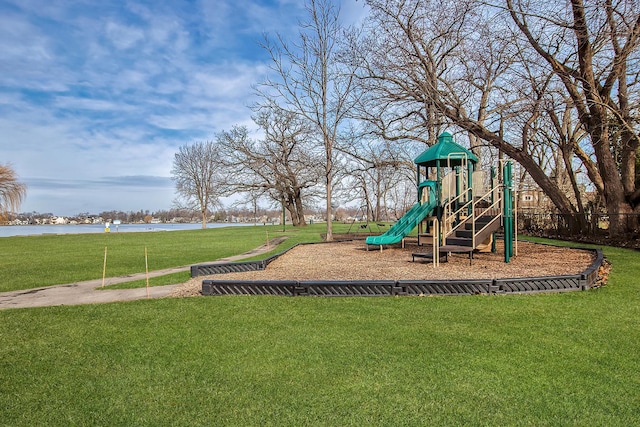 view of play area featuring a yard and a water view