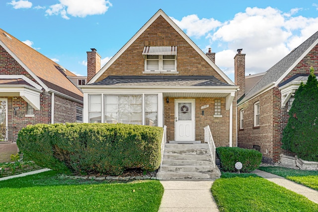 bungalow-style house with a front lawn