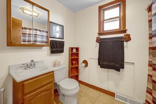 bathroom featuring vanity, toilet, and walk in shower