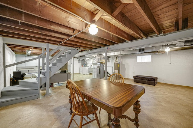 dining room with separate washer and dryer, wooden ceiling, and gas water heater