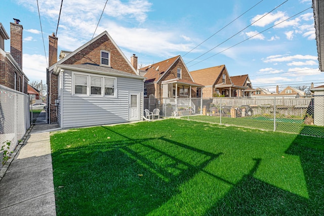 back of house featuring a lawn